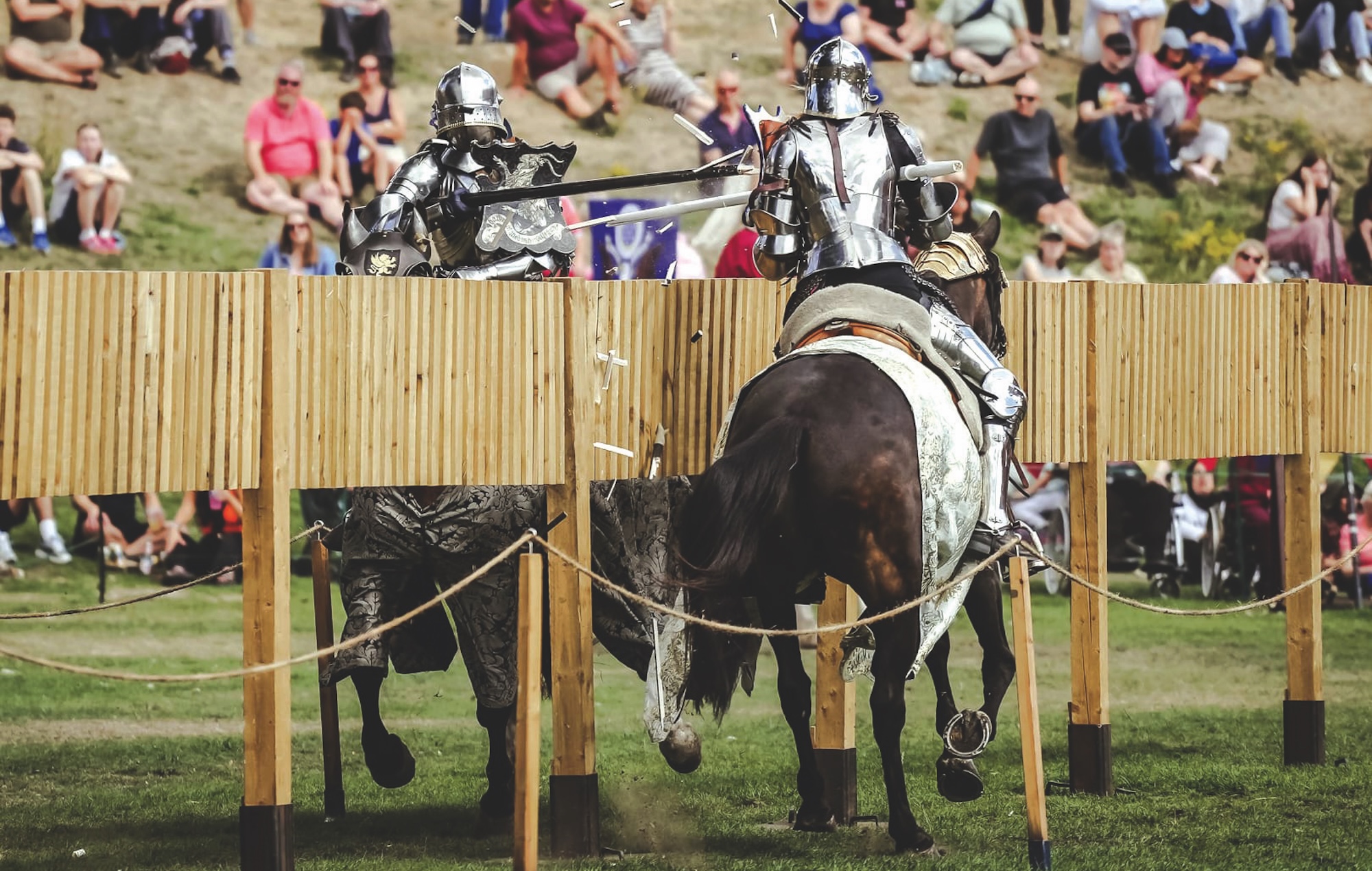 Two armoured knights jousting