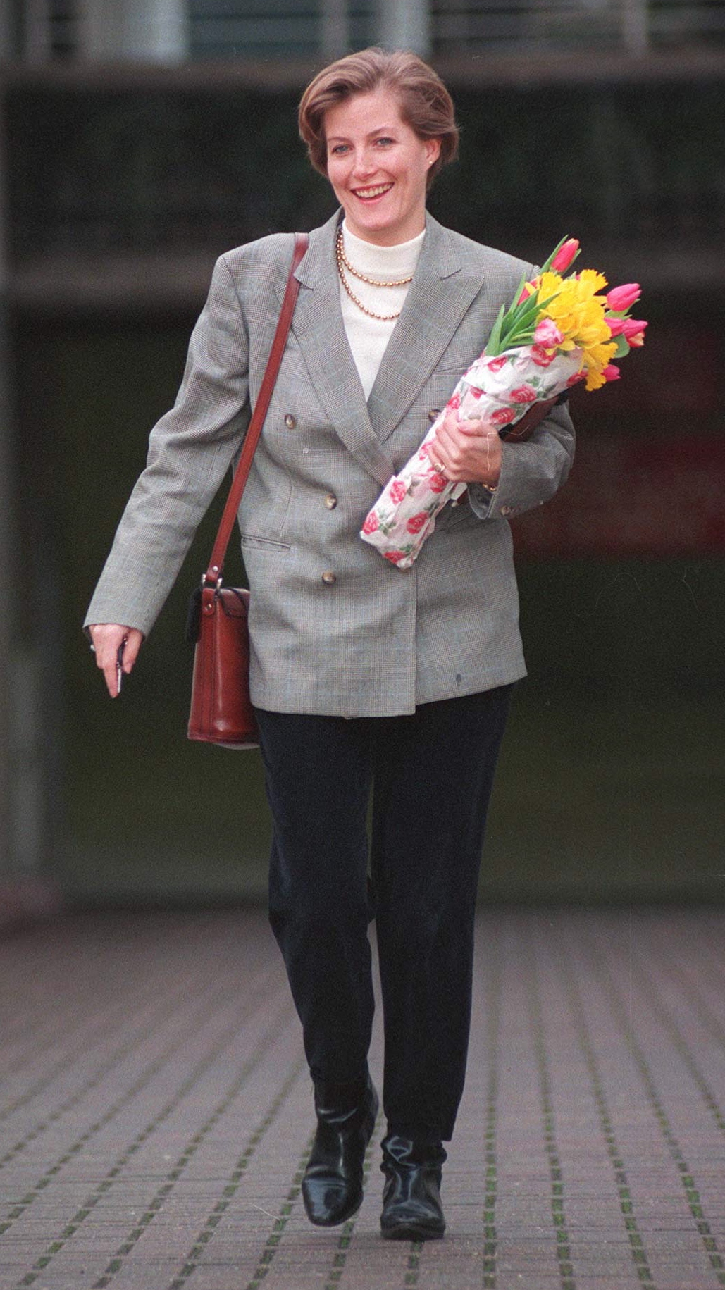 Duchess Sophie holds flowers as she walks to work on her 30th birthday