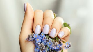 A hand with a light blue manicure