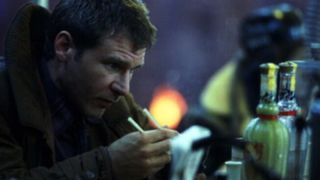 Harrison Ford as Rick Deckard fixing a machine in the movie Blade Runner.