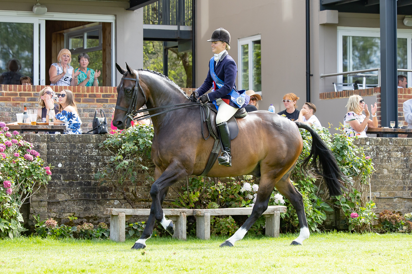 Tidy Town and Alice Homer canter around the international arena having won the small hunter title at the 2026 Royal International Horse Show