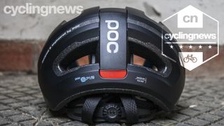 POC Omne Eternal Spin helmet resting on concrete slab