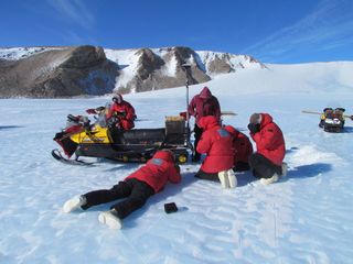 Scientists work to gather meteorites in this scene from a recent meteorite-hunting season of the Antarctic Search for Meteorites Program run by Case Western Reserve University.