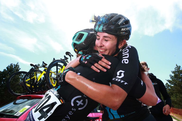 Juliette Labous celebrates with a DSM team mate after winning the general classification at the 2022 Vuelta a Burgos