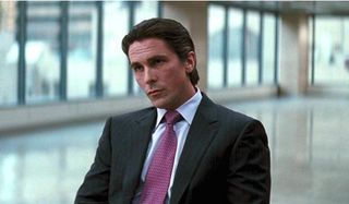 The Dark Knight Rises Christian Bale wears a fine suit in the Wayne Enterprises office