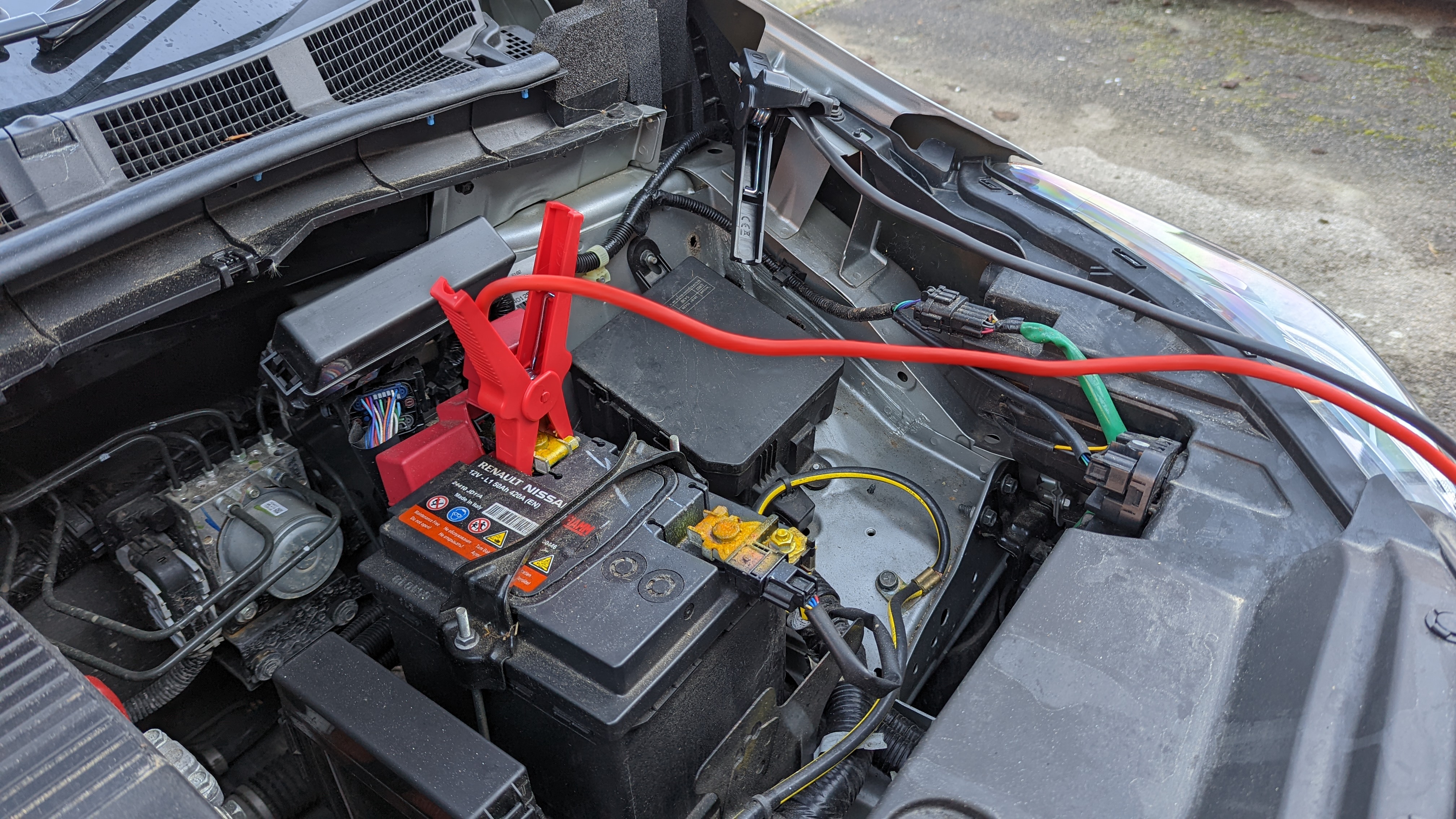 car battery with jumper cables attached