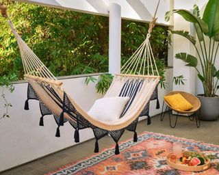 double weave fringed hammock colonial in navy blue on a small porch area - west elm