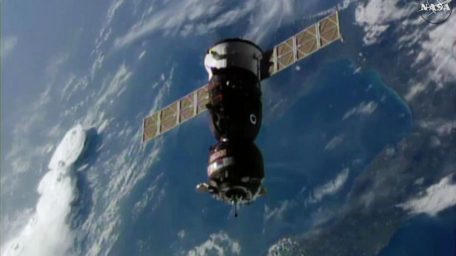 A Russian Soyuz MS-02 spacecraft carrying NASA astronaut Shane Kimbrough and Russian cosmonauts Sergey Ryzhikov and Andrey Borisenko nears the International Space Station ahead of docking in this still image from a video camera on the space station captur