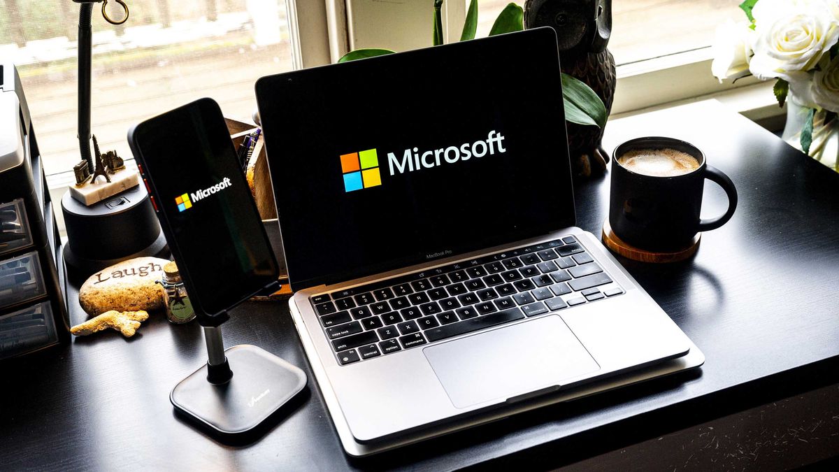 The Microsoft logo on a smartphone and laptop arranged in Crockett, California, US, on Friday, Dec. 29, 2023. 