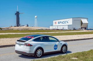 SpaceX's Tesla Model X astronaut transfer vehicle is emblazoned with both NASA's insignia and its retro logotype.