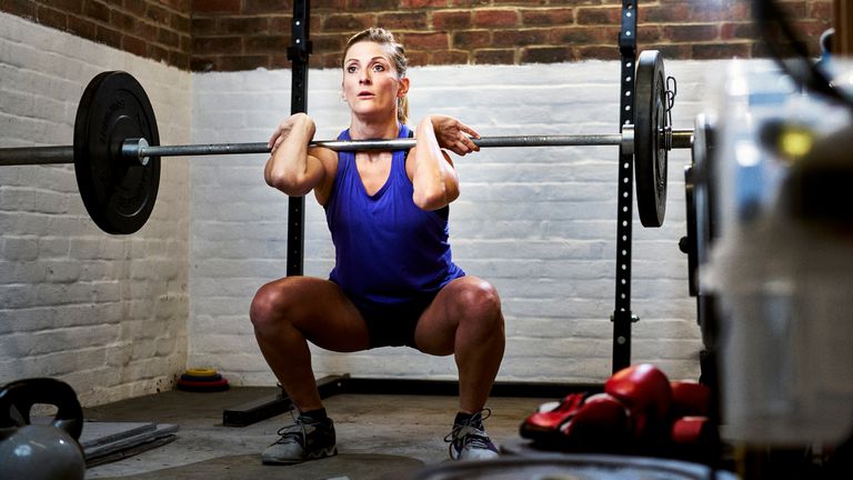 Progressive overload explained: Image of woman lifting weights