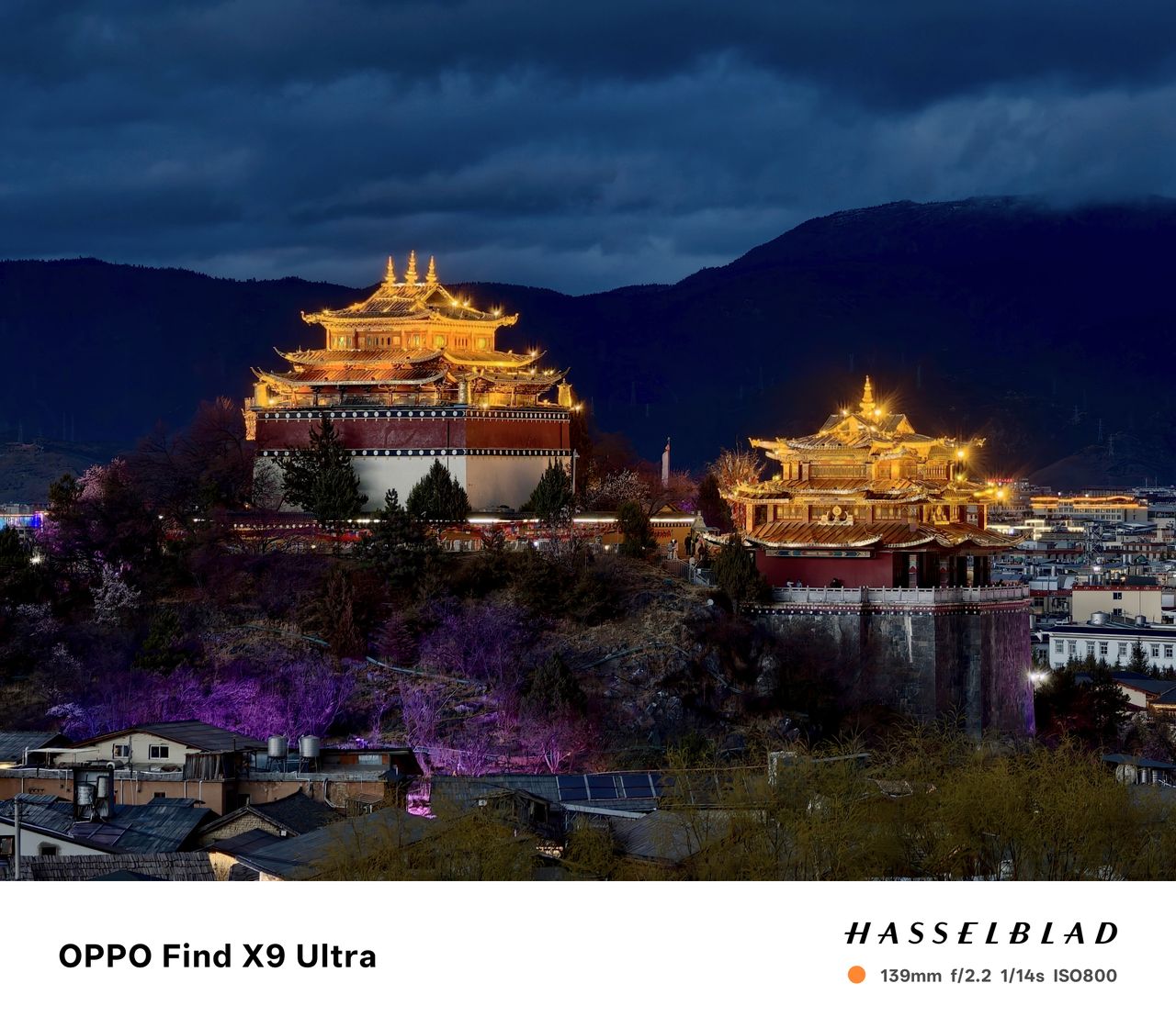 Monastery above a town at night, it's lit up
