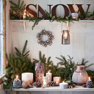 christmas decoration with plants and designed candles