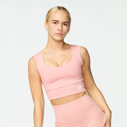 Young blonde woman wearing rose Forme Power Bra