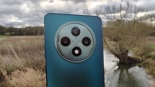 The Oppo Reno 12 FS camera module over a river background