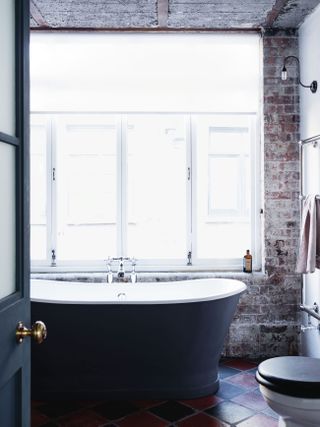 Industrial style bathroom with light fittings by Fritz Fryer