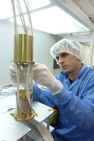 Michael Passaretti assembles the Glory spacecraft's twist capsule in Honeybee Robotics' New York City cleanroom.