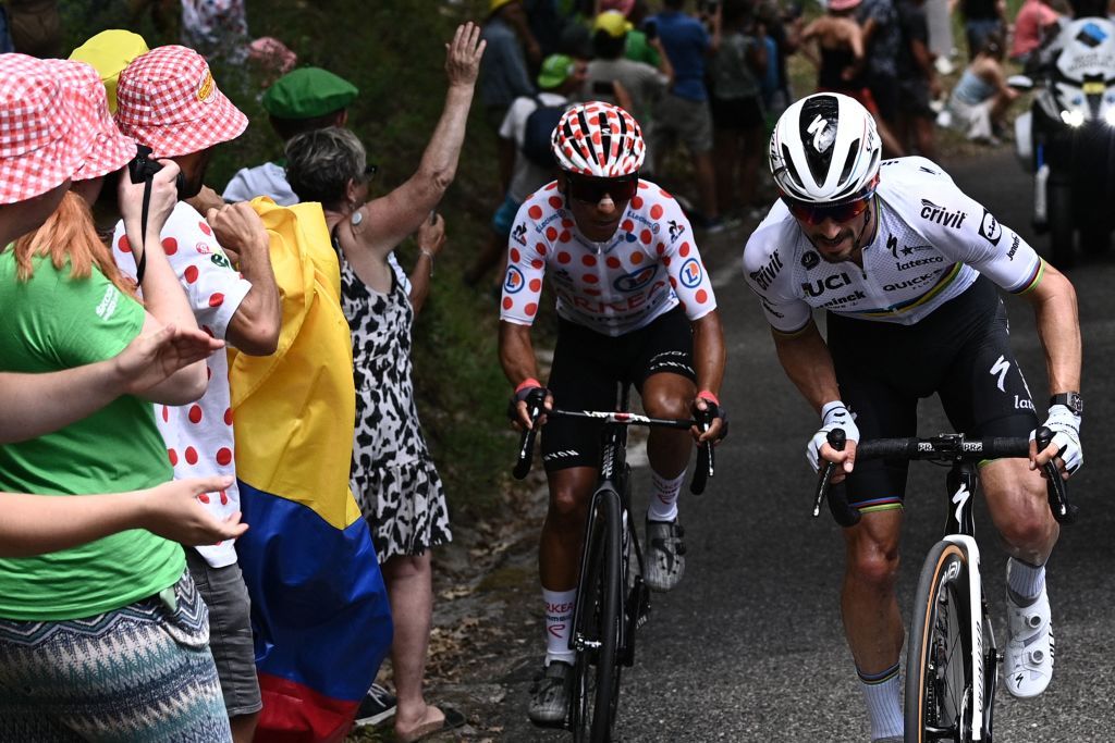 TOPSHOT Team Arkea Samsics Nairo Quintana of Colombia wearing the best climbers polka dot jersey L rides next to Team Deceuninck Quicksteps Julian Alaphilippe of France during the 11th stage of the 108th edition of the Tour de France cycling race 198 km between Sorgues and Malaucene on July 07 2021 Photo by AnneChristine POUJOULAT AFP Photo by ANNECHRISTINE POUJOULATAFP via Getty Images