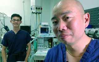 How the NHS Changed Our World - presenter Giles Yeo (R) in Papworth operating theatre with surgeon Steven Tsui