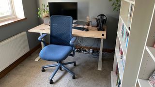 A photo of the blue Verve chair, turned away from a home office desk.