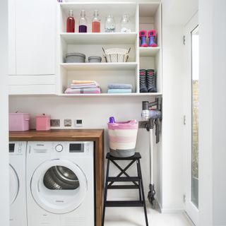 front loader washing machine in white laundry room