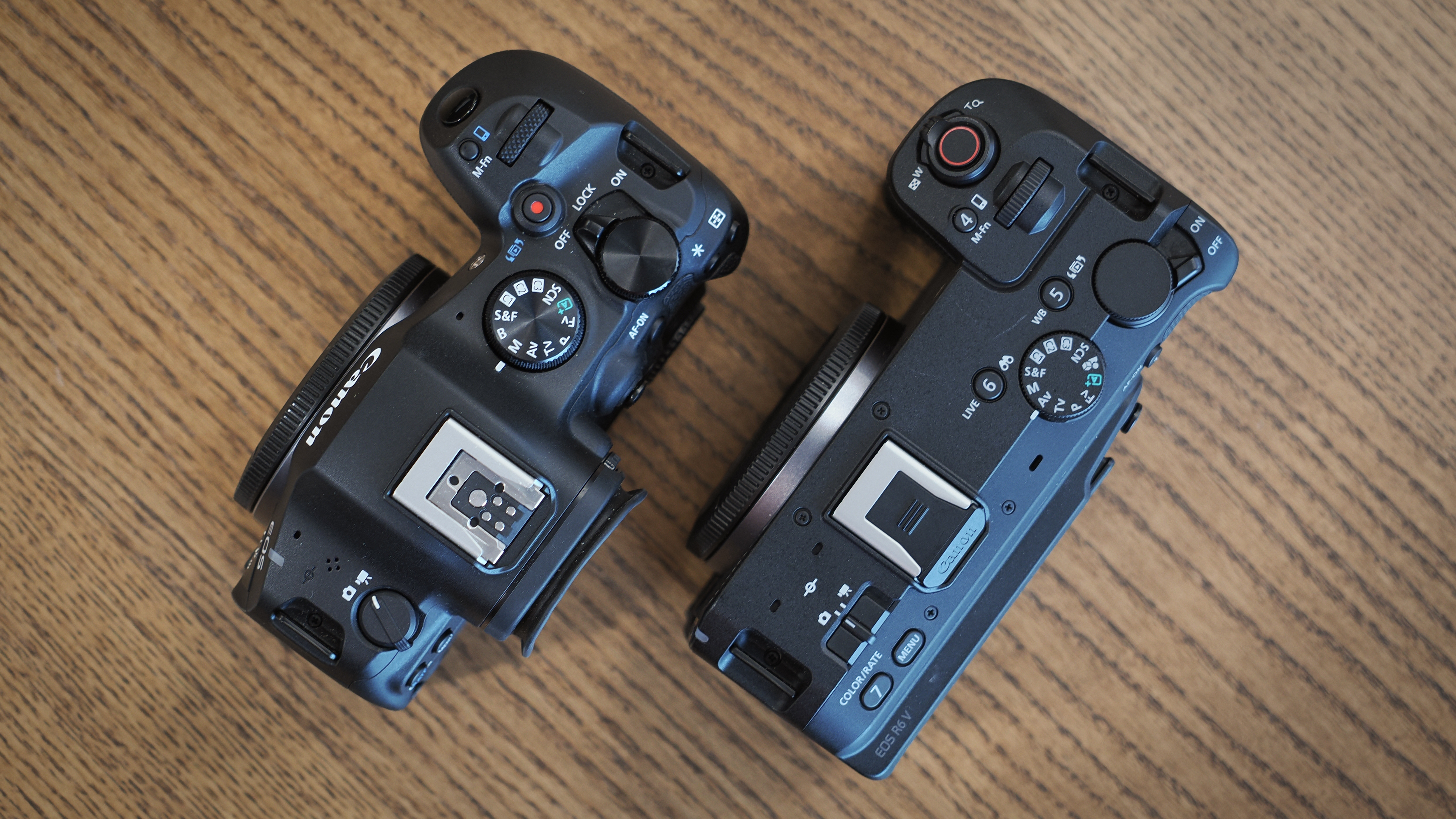 Canon EOS R6 V and R6 Mark III on a wooden surface