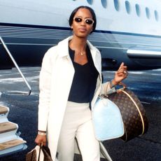 An image of Naomi Campbell travelling in 1998.