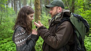 (L to R) Thomasin Mackenzie as Tom and Ben Foster as Will share a moment in the woods in Leave No Trace