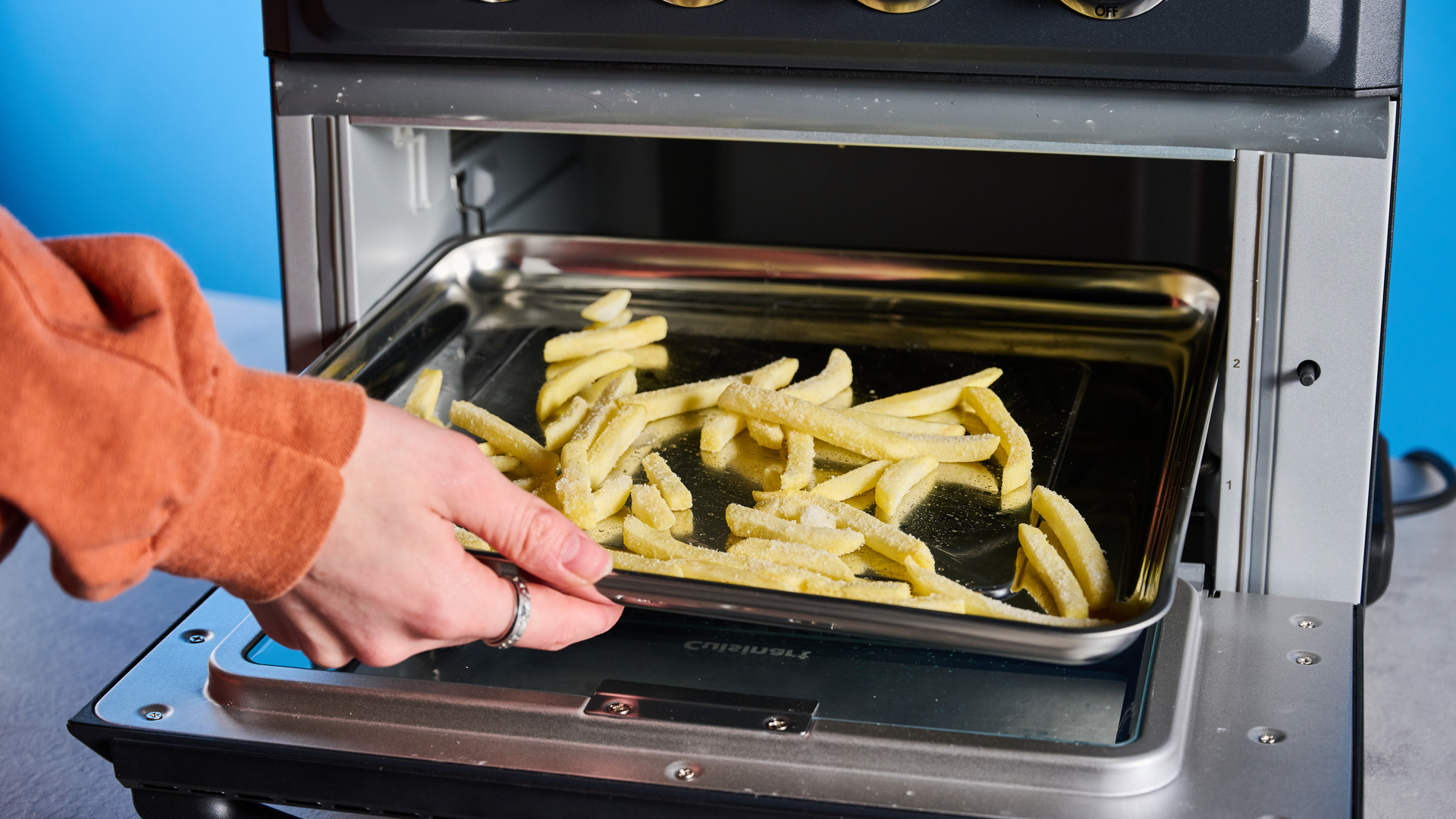 the cuisinart air fryer and toaster oven toa-60 with a black exterior, four temperature and timer dials