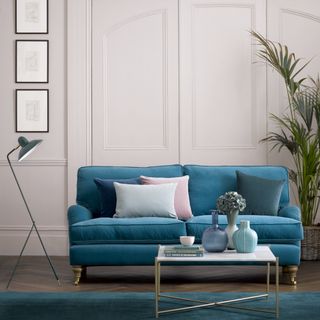 The Sofa.com Bluebell Sofa Bed in blue upholstery in a panelled room