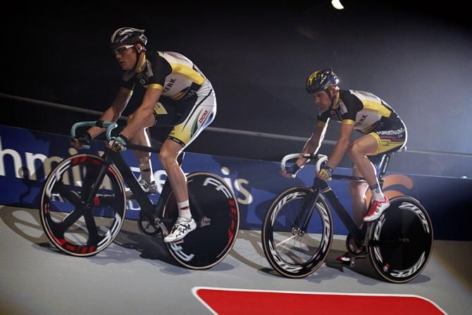 Teammates Pim Ligthart and Michael M&oslash;rk&oslash;v circle the top of the track, building speed for their team time trial event.