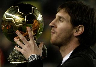 Barcelona&#039;s Argentinian forward Lionel Messi poses with his trophy of European footballer of the year award, the &quot;Ballon d&#039;Or&quot; (Golden ball), before the Spanish League match Barcelona against Espanyol at the New Camp Stadium in Barcelona, on December 12, 2009. AFP PHOTO / JOSEP LAGO (Photo credit should read JOSEP LAGO/AFP via Getty Images)