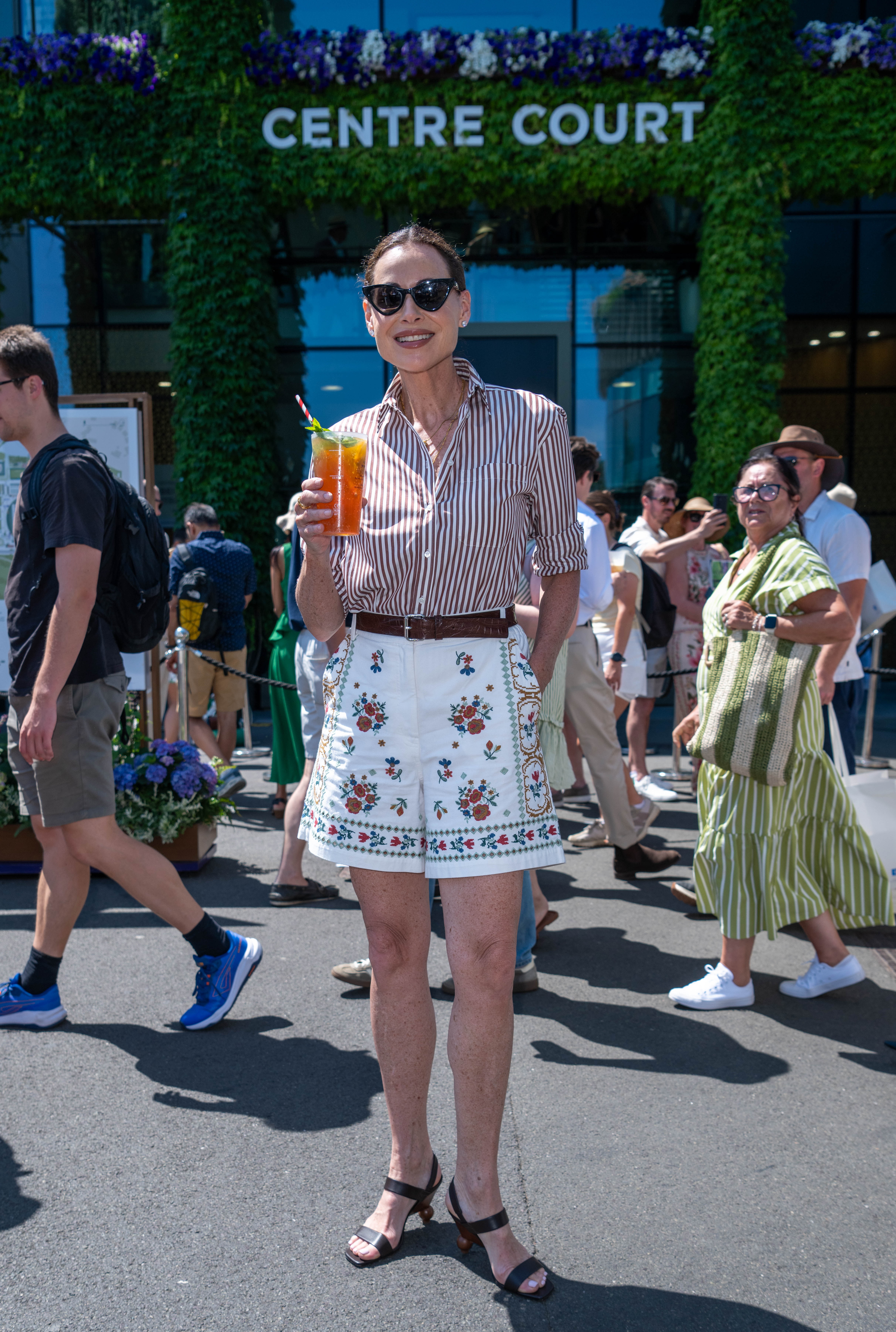 Minnie Driver in shorts and shirt