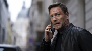 A still from the Chief of Station movie of Aaron Eckhart on the phone.