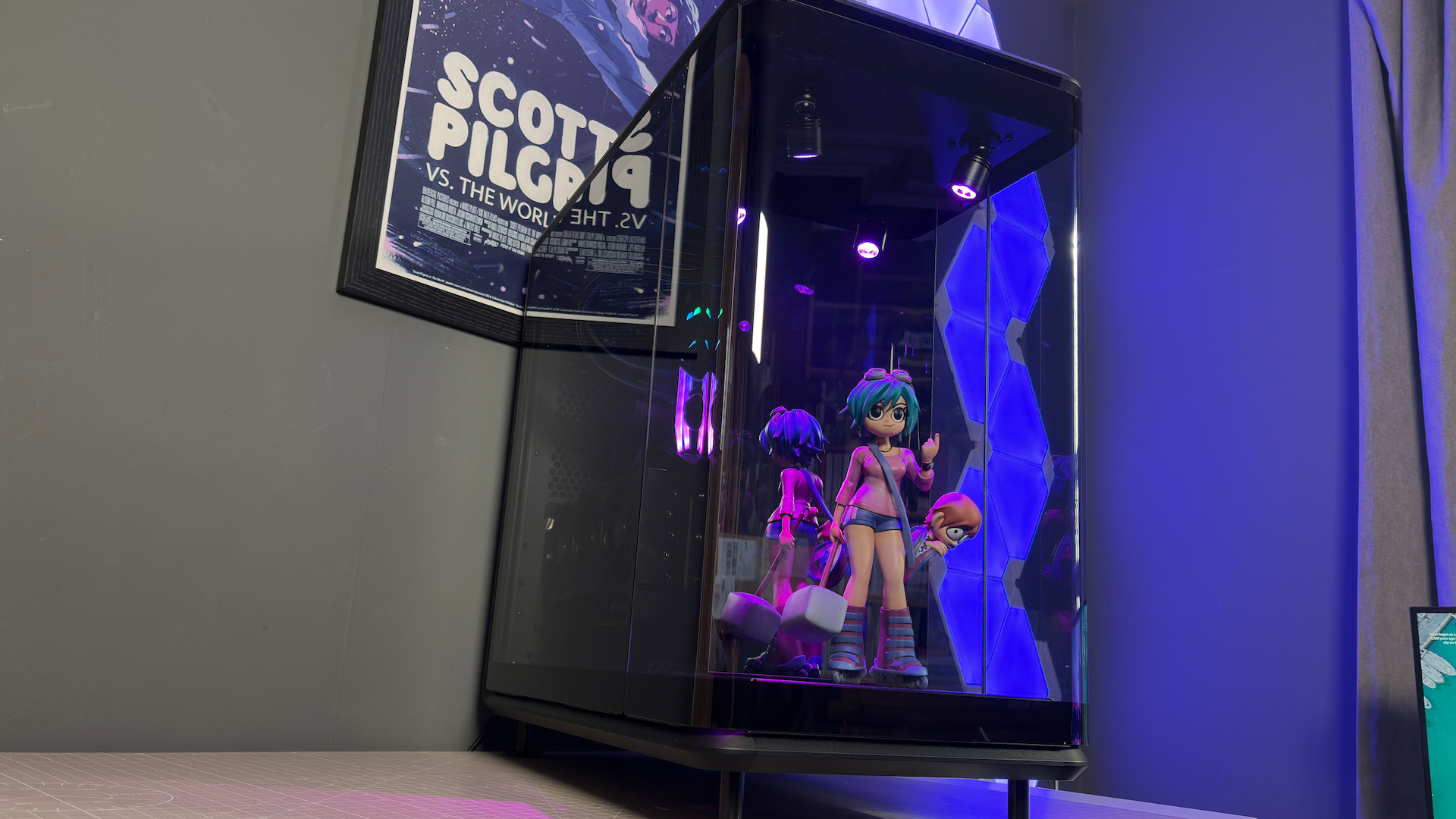The CoolerMaster MasterFrame 360 Panoramic PC case with various components installed on a desk.