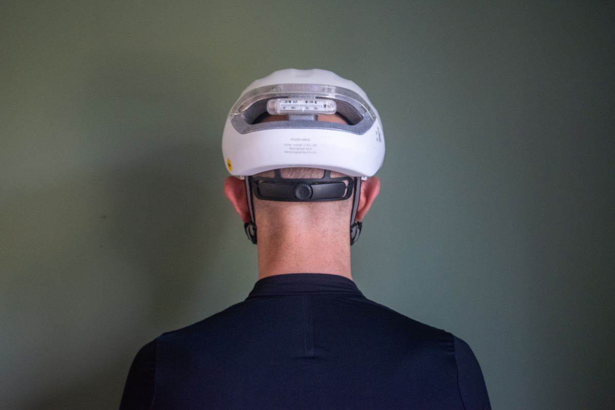 A man wearing a white fizik kudo aero helmet