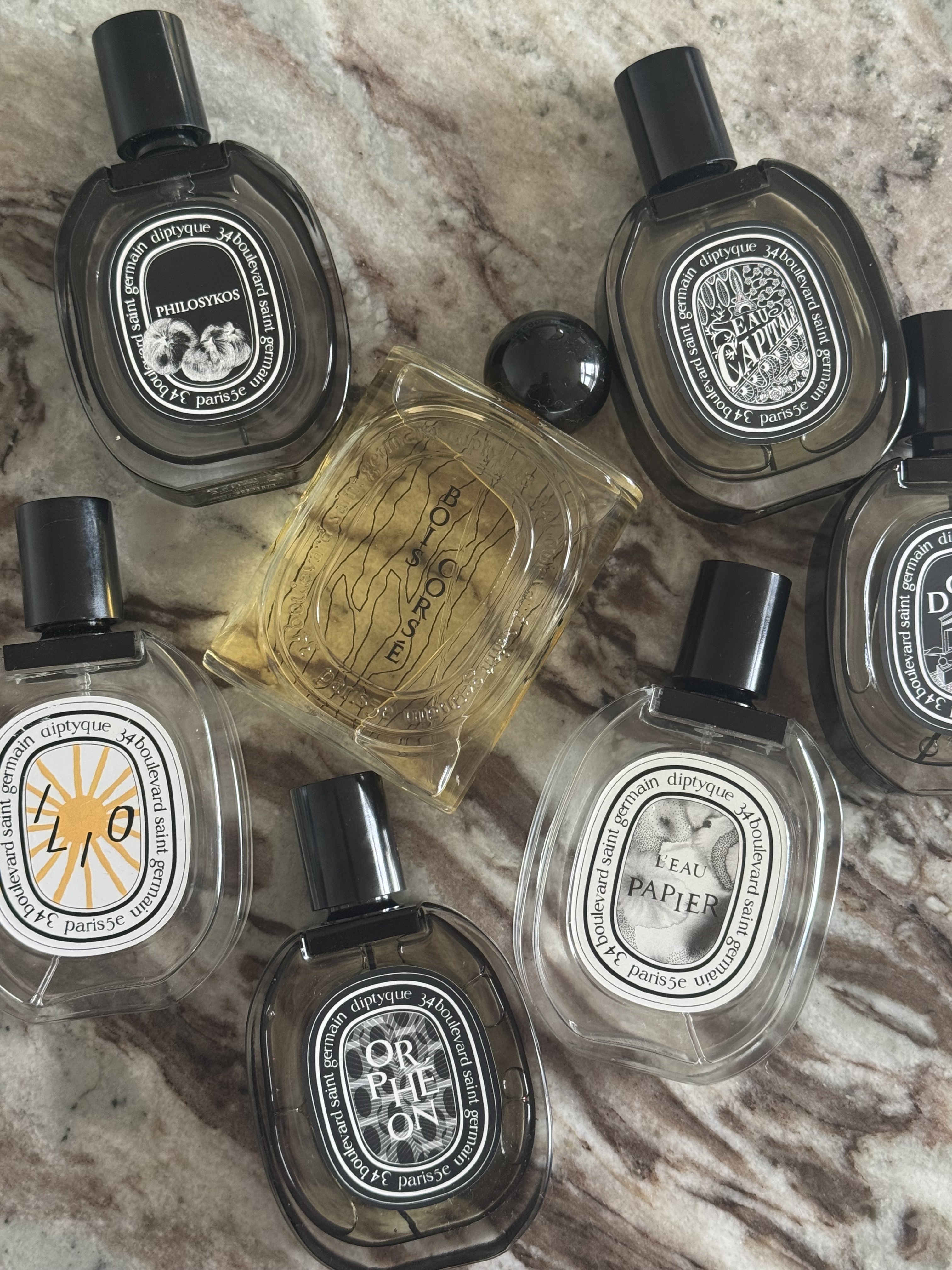Eleanor's collection of Diptyque perfumes on a marble table