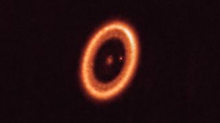 A solar system in the process of forming with a moon-forming disc around an exoplanet