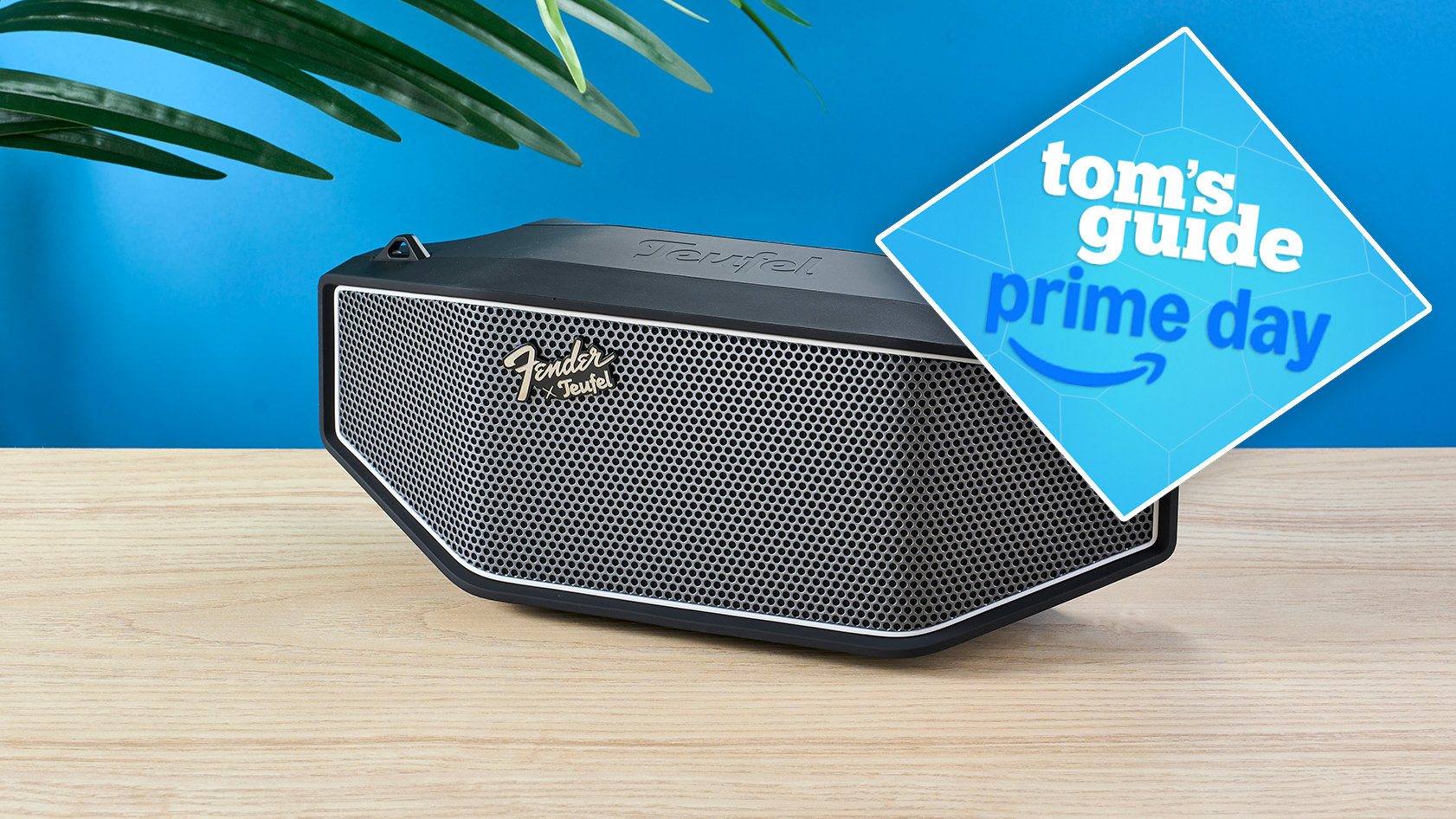The Fender x Teufel Rockster Cross on a wooden table with a blue background and a blue Tom's Guide Prime Day deal badge in the top right corner of the image.