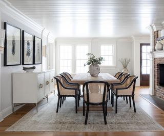 dining room with black and cane chairs and white walls