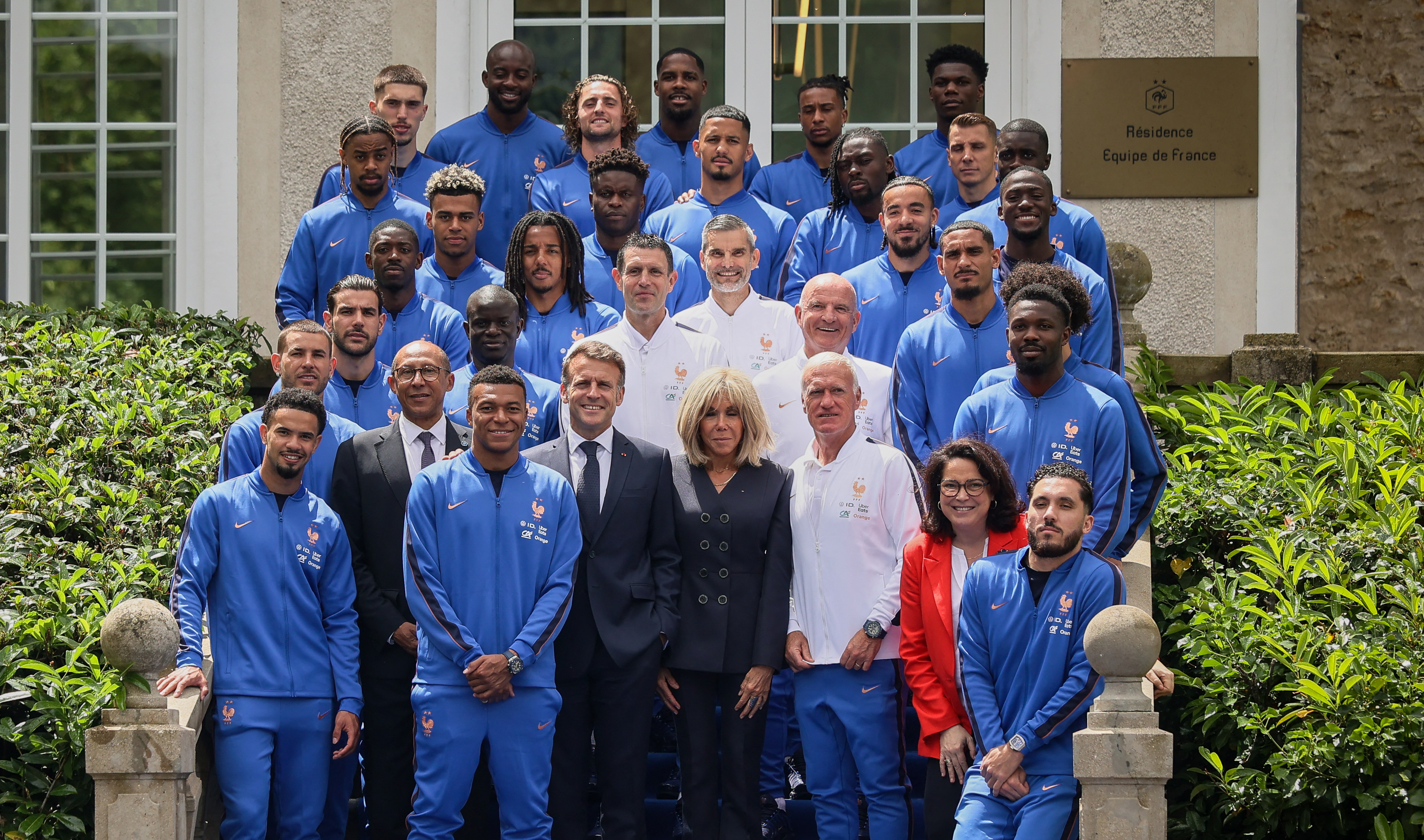 France's President Emmanuel Macron (first row, C-L) and his wife Brigitte Macron (first row, C-R) pose with the French national football team during a visit at the national team training grounds in Clairefontaine-en-Yvelines, southwest of Paris on June 2, 2026, ahead of 2026 FIFA World Cup football tournament. (Photo by Thomas Padilla / POOL / AFP)