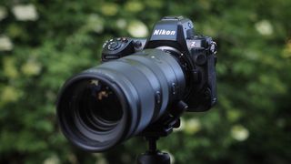 Nikon Z8 camera, pictured against a background of blurred green foliage