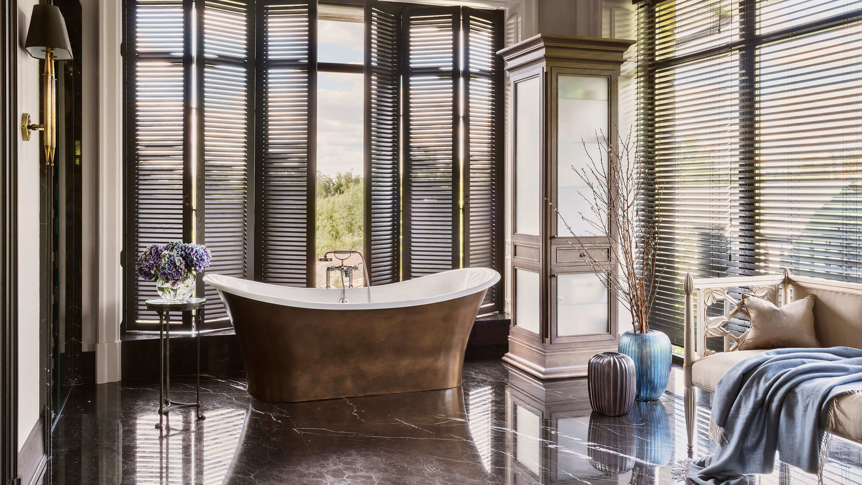 metallic freestanding bath in large bathroom