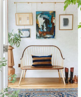 An entryway bench with a small gallery wall hanging above