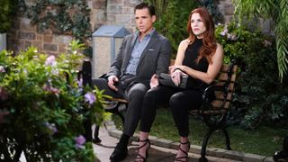 Jason Thompson and Courtney Hope as Billy and Sally on a bench in The Young and the Restless