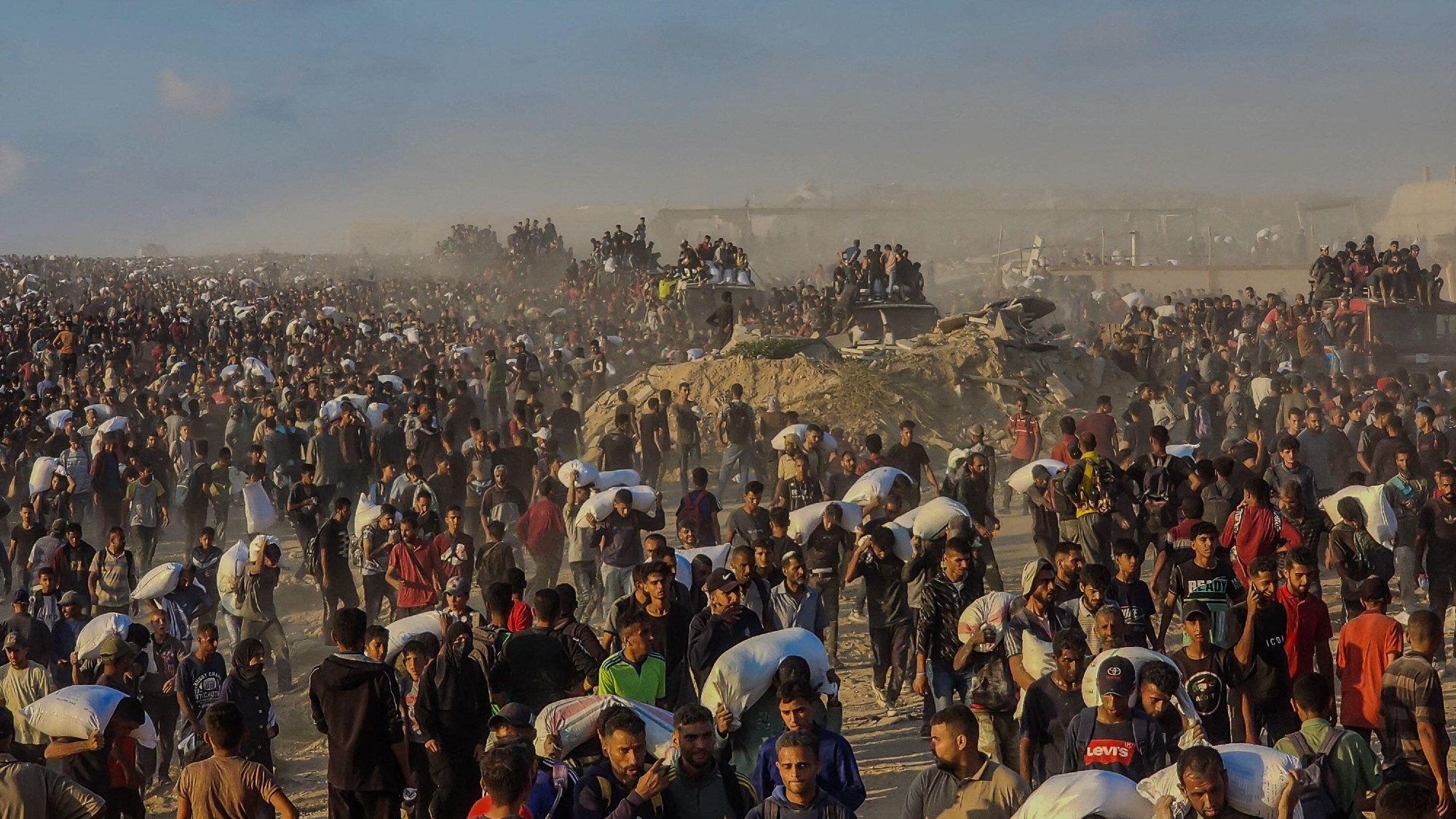 Palestinians at a Gaza Humanitarian Foundation aid centre in Al-Sudaniya, north of Gaza City