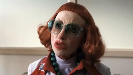 A screenshot of Amy Madigan as Gladys wearing glasses and smeared lipstick in Weapons. 