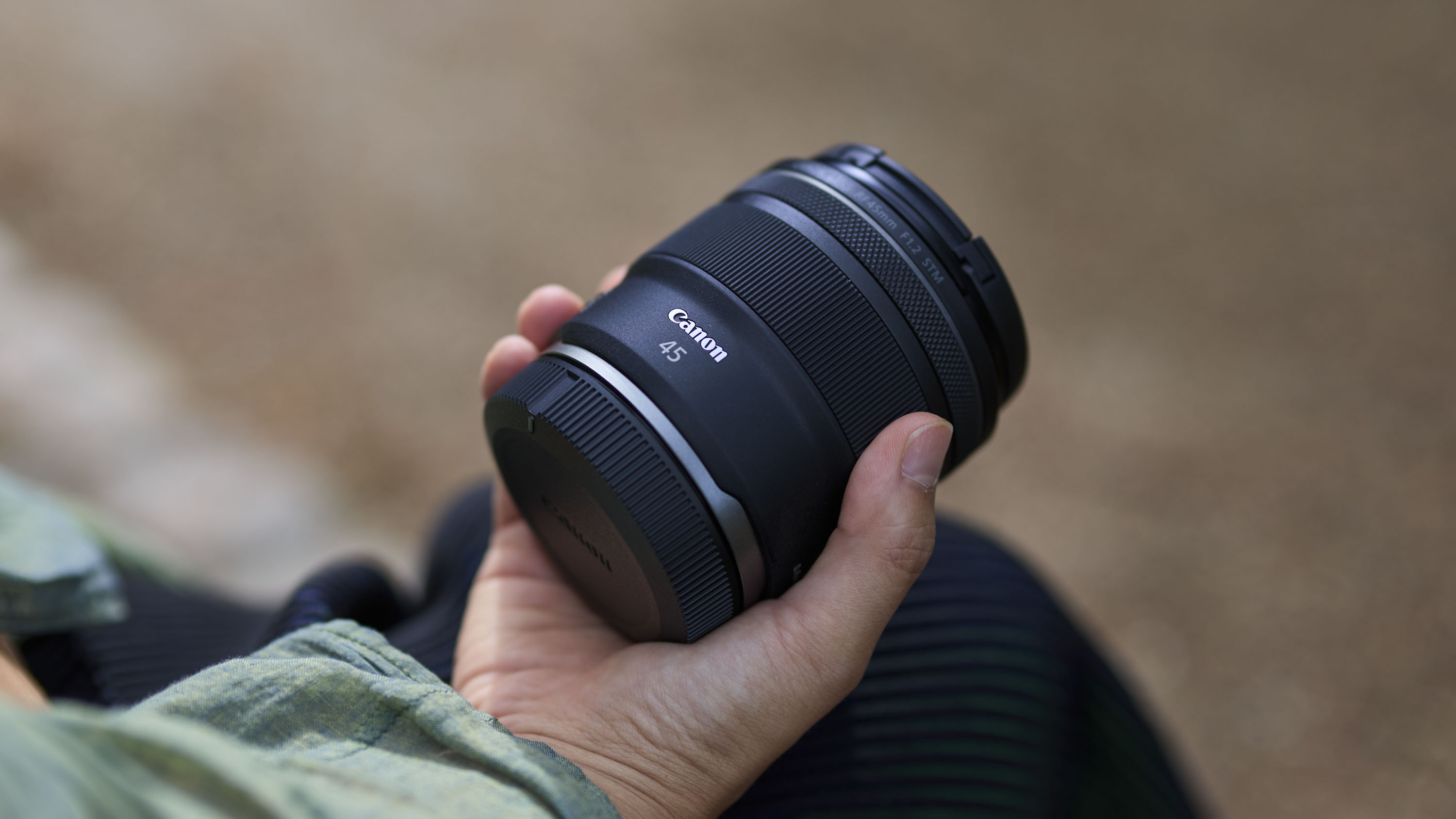 Canon RF 45mm F1.2 STM lens in the hand