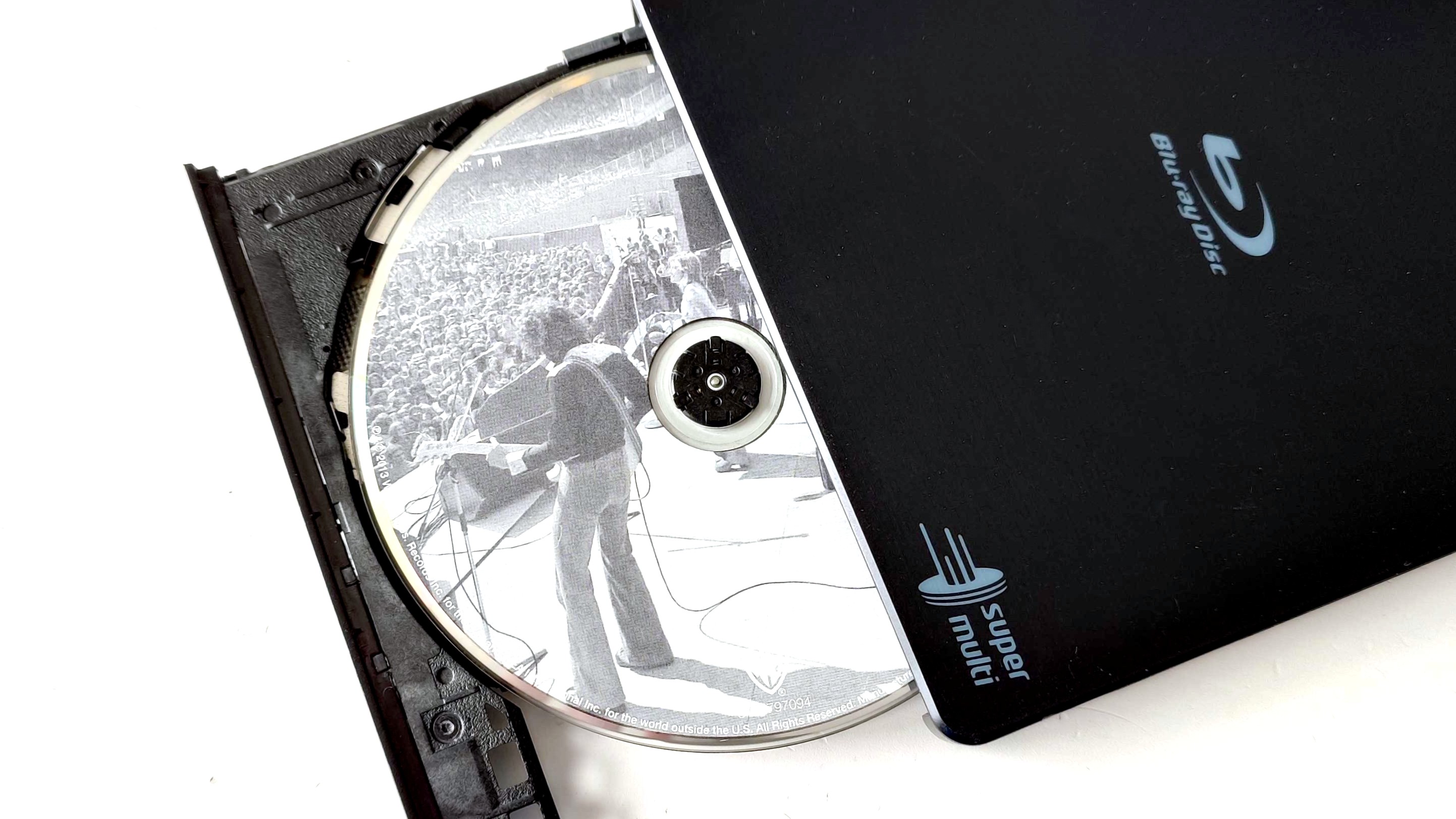 An LG USB Blu-ray drive open showing a Fleetwood Mac CD inside