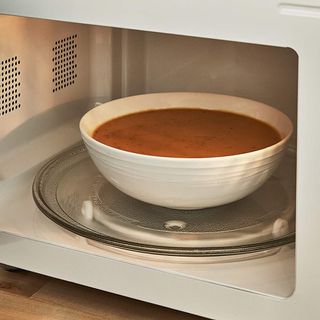Inside of Swan Nordic Digital Microwave with tomato soup bowl